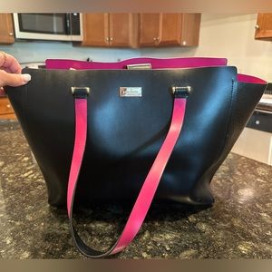 Black Kate spade bag. Small white spot on back as shown in picture.